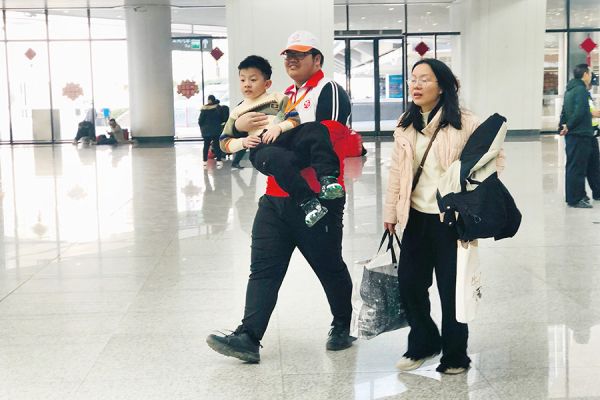 青年志愿者帮助行动不便的孩子抵达站台